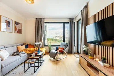 a living room with a couch and a tv at Prague Days - One-Bedroom Apartment with Balcony, Garage & 250 Mbs WiFi in Prague