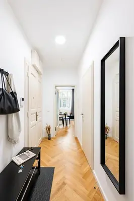 a hallway with a mirror and a black desk at Prague Days - One-Bedroom Apartment with Netflix in Holešovice in Prague