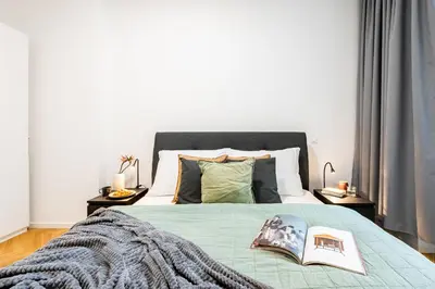 a bedroom with a bed with a book on it at Prague Days - One-Bedroom Apartment with Netflix in Holešovice in Prague