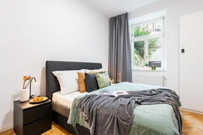 a bedroom with a bed and a window at Prague Days - One-Bedroom Apartment with Netflix in Holešovice in Prague