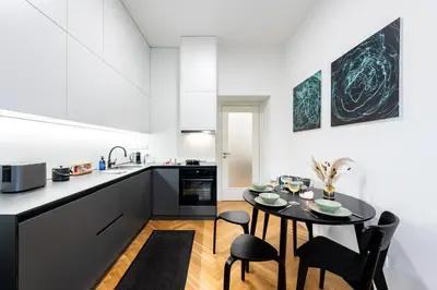 a kitchen and dining room with a table and chairs at Prague Days - One-Bedroom Apartment with Netflix in Holešovice in Prague