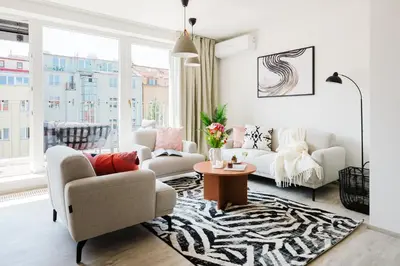 a living room with a couch and a table at Prague Days - Top Floor Apartments with Terrace & AC near Vyšehrad Castle in Prague