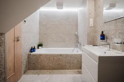 a bathroom with a tub and a sink at Prague Days - Top Floor Apartments with Terrace & AC near Vyšehrad Castle in Prague