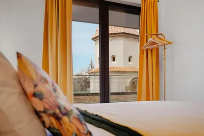 a bedroom with a window with a view of a building at Mucha Residence - with free weekend parking in Prague