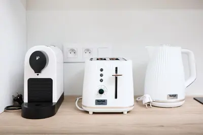 a toaster and a coffee maker on a table at Mucha Residence - with free weekend parking in Prague