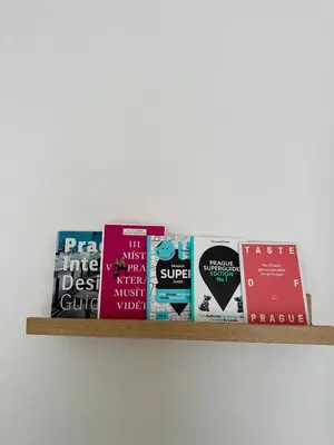 a shelf full of books on a wall at Prague Airport Apartment in Tuchoměřice