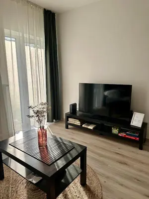 a living room with a tv and a coffee table at Prague Airport Apartment in Tuchoměřice