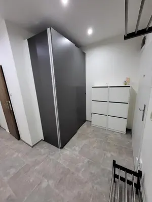 a room with a closet with a metal door at Fox Den Prague in Prague