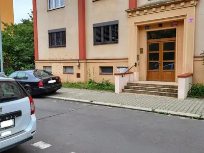 a car parked in front of a building with a door at Fox Den Prague in Prague