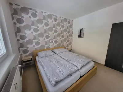 a small bed in a room with a wall at Fox Den Prague in Prague