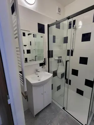 a bathroom with a sink and a shower at Fox Den Prague in Prague