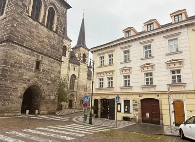 a street with buildings and a church and a car at Petrska Cozy 2 bedroom apartment near Old Town in Prague