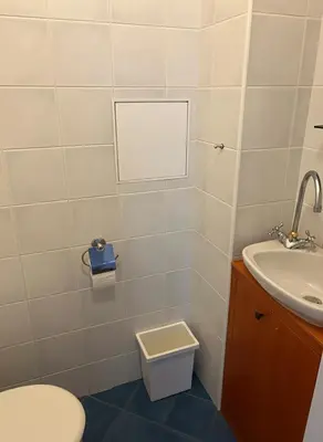 two beds in a small room with white walls at Petrska Cozy 2 bedroom apartment near Old Town in Prague