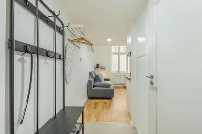 a living room with a gray couch and a table at HOMELY I Central 28m2 loft I ELEVATOR I Self Check-In in Prague