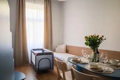 a dining room with a blue table and chairs at Modern design studio with fast WI-FI in Prague
