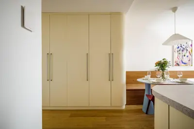 a kitchen with white cabinets and a table at Modern design studio with fast WI-FI in Prague
