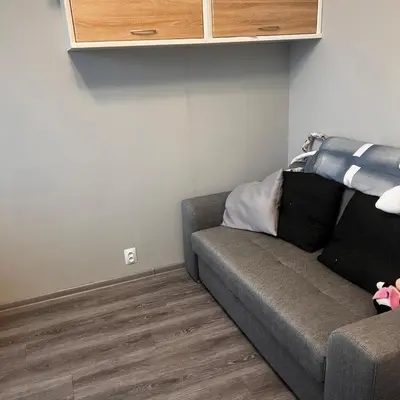 a living room with a couch in a room at Apartment in Prague in a quiet location close to the center in Prague
