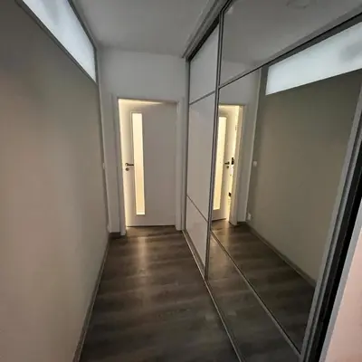 an empty hallway with mirrors in a building at Apartment in Prague in a quiet location close to the center in Prague