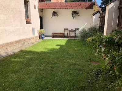 a yard with a table and chairs in a house at Prague house in Green Oasis 10min to the downtown in Prague