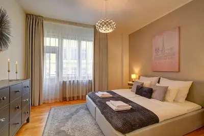 a bedroom with a large bed and a large window at Modern & Elegance Suite Apartment Prague in Prague