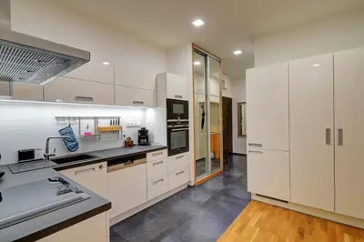 a kitchen with white cabinets and a sink at Modern & Elegance Suite Apartment Prague in Prague