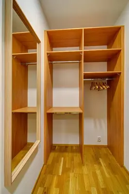a walk in closet with wooden shelves and wooden floors at Modern & Elegance Suite Apartment Prague in Prague