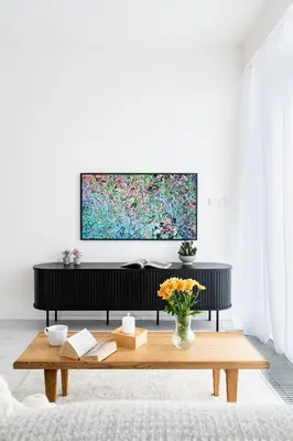 a living room with a table and a tv at Prague Days - Family Friendly Two-Bedroom Apartment with AC, Garage and Terrace in Holešovice in Prague