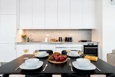 a table with glasses of wine and food on it at Prague Days - Family Friendly Two-Bedroom Apartment with AC, Garage and Terrace in Holešovice in Prague