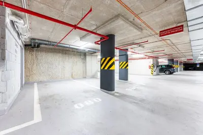 an empty parking garage with a car parked in it at Prague Days - Family Friendly Two-Bedroom Apartment with AC, Garage and Terrace in Holešovice in Prague
