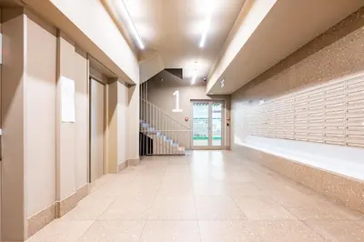 a hallway of a building with a staircase and a hallwayngth at Prague Days - Family Friendly Two-Bedroom Apartment with AC, Garage and Terrace in Holešovice in Prague