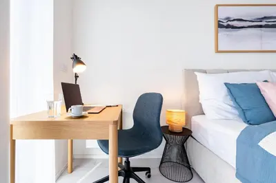 a bedroom with a desk and a bed and a desk and chair at Prague Days - Family Friendly Two-Bedroom Apartment with AC, Garage and Terrace in Holešovice in Prague