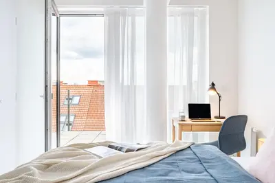 a bedroom with a bed and a desk and a window at Prague Days - Family Friendly Two-Bedroom Apartment with AC, Garage and Terrace in Holešovice in Prague