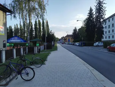 two bikes parked on a sidewalk next to a street at Penzion Tenis in Poděbrady