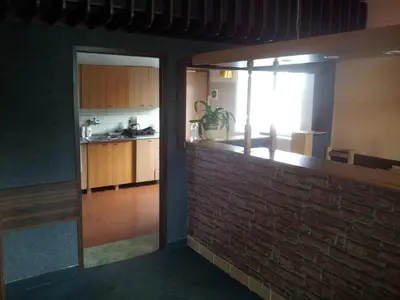 a kitchen with a brick wall and a window at Penzion Tenis in Poděbrady