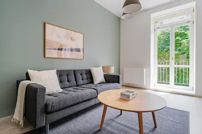 a living room with a couch and a table at Blueground Nusle balcony nr Vyšehrad PRG-74 in Prague