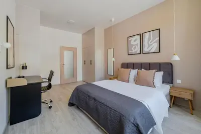 a bedroom with a bed and a desk in it at Blueground Nusle balcony nr Vyšehrad PRG-74 in Prague