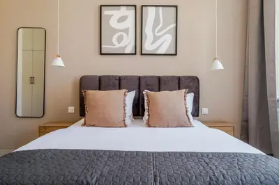a bedroom with a large bed with two pillows at Blueground Nusle balcony nr Vyšehrad PRG-74 in Prague