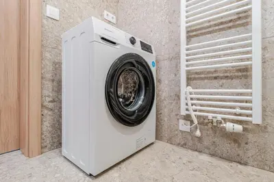 a white washing machine in a room at Blueground Nusle balcony nr Vyšehrad PRG-74 in Prague