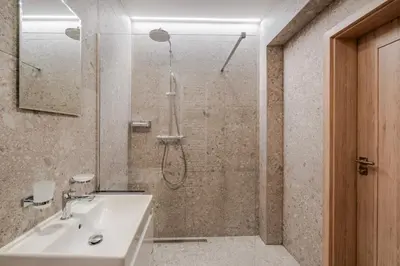 a bathroom with a shower and a sink at Blueground Nusle balcony nr Vyšehrad PRG-74 in Prague