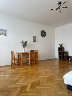a room with a table and chairs and a dining room at Apartmá in Prague