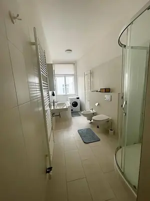 a bathroom with a glass shower and a sink at Apartmá in Prague