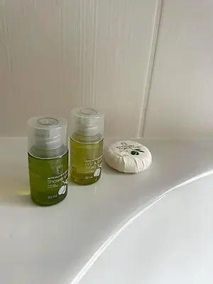 two containers of green liquid sitting on a white table at Apartmá in Prague