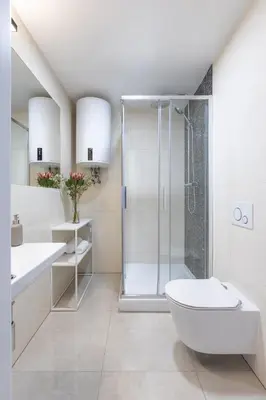 a white bathroom with a shower and a toilet at Prague Center Studio in Prague