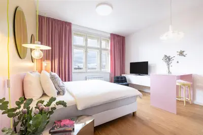 a hotel room with a bed and a television at Prague Center Studio in Prague
