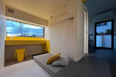 a room with a yellow counter and a window at Stylish tiny house in an urban oasis in Prague