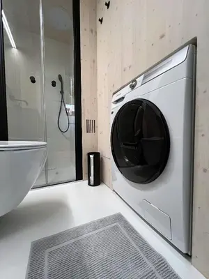 a washing machine in a bathroom with a sink at Stylish tiny house in an urban oasis in Prague