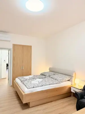 a kitchen with a wooden table and a dining room at Apartment Old Town Square in Prague