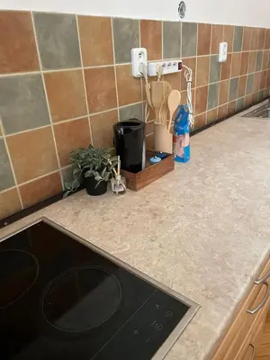 a kitchen counter with a black dishwasher in a kitchen at Apartmá ve Středu Prahy in Prague