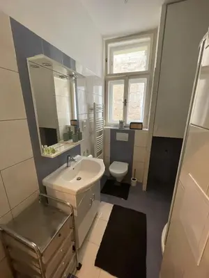 a bathroom with a sink and a toilet and a mirror at Apartmá ve Středu Prahy in Prague