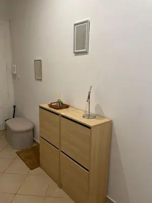 a bathroom with a wooden dresser and a toilet at Apartmá ve Středu Prahy in Prague